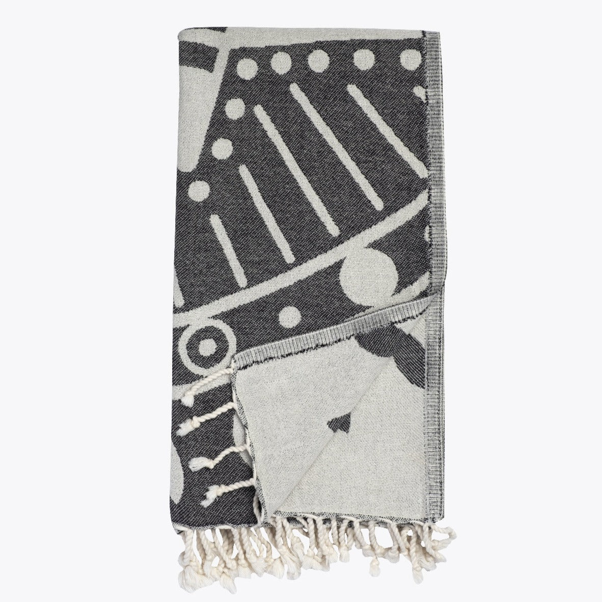 Gray and white patterned towel with fringes on a white background
