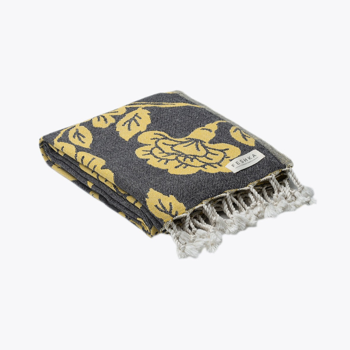 Folded towel with yellow floral patterns on a dark background
