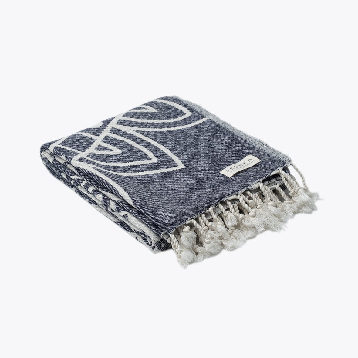 Blue towel with white patterns and tassels on a white background
