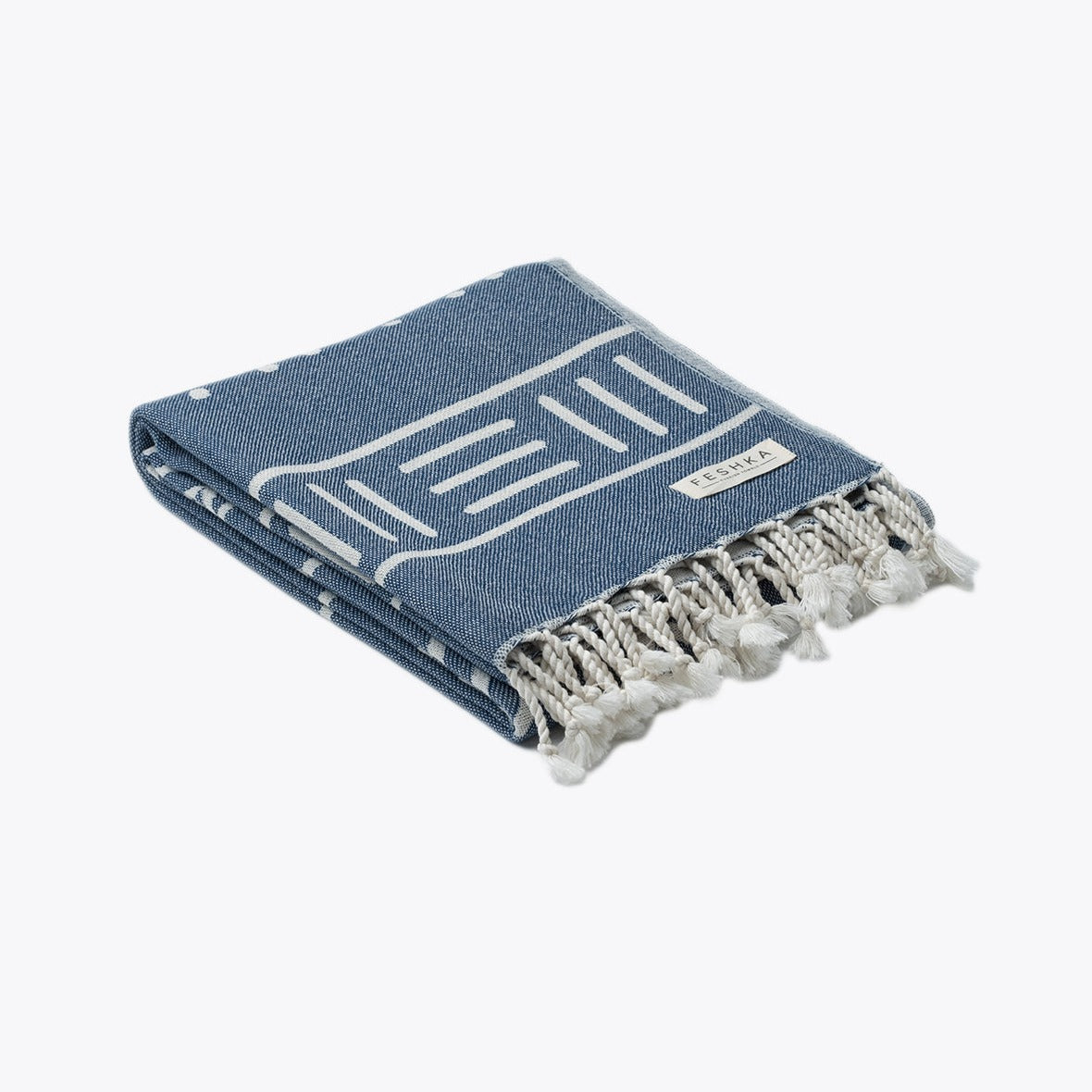 Blue towel with white patterns and fringes on a white background