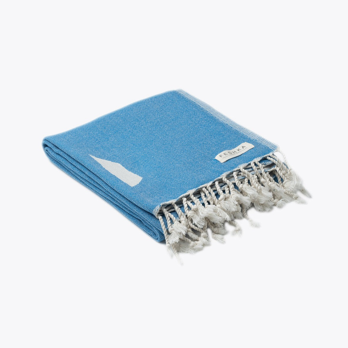 Blue towel with white tassels on a white background