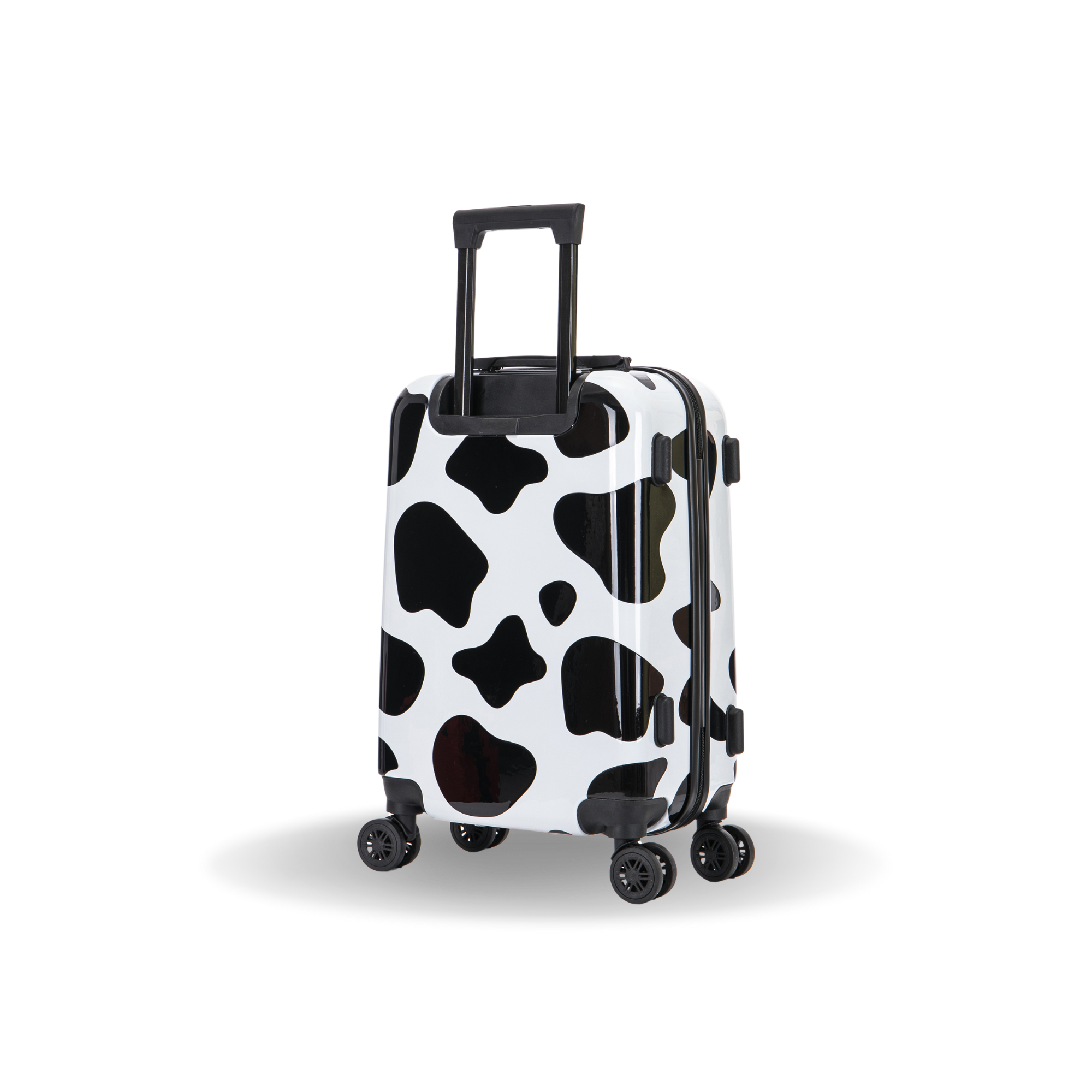 Black and white cow print suitcase on a white background