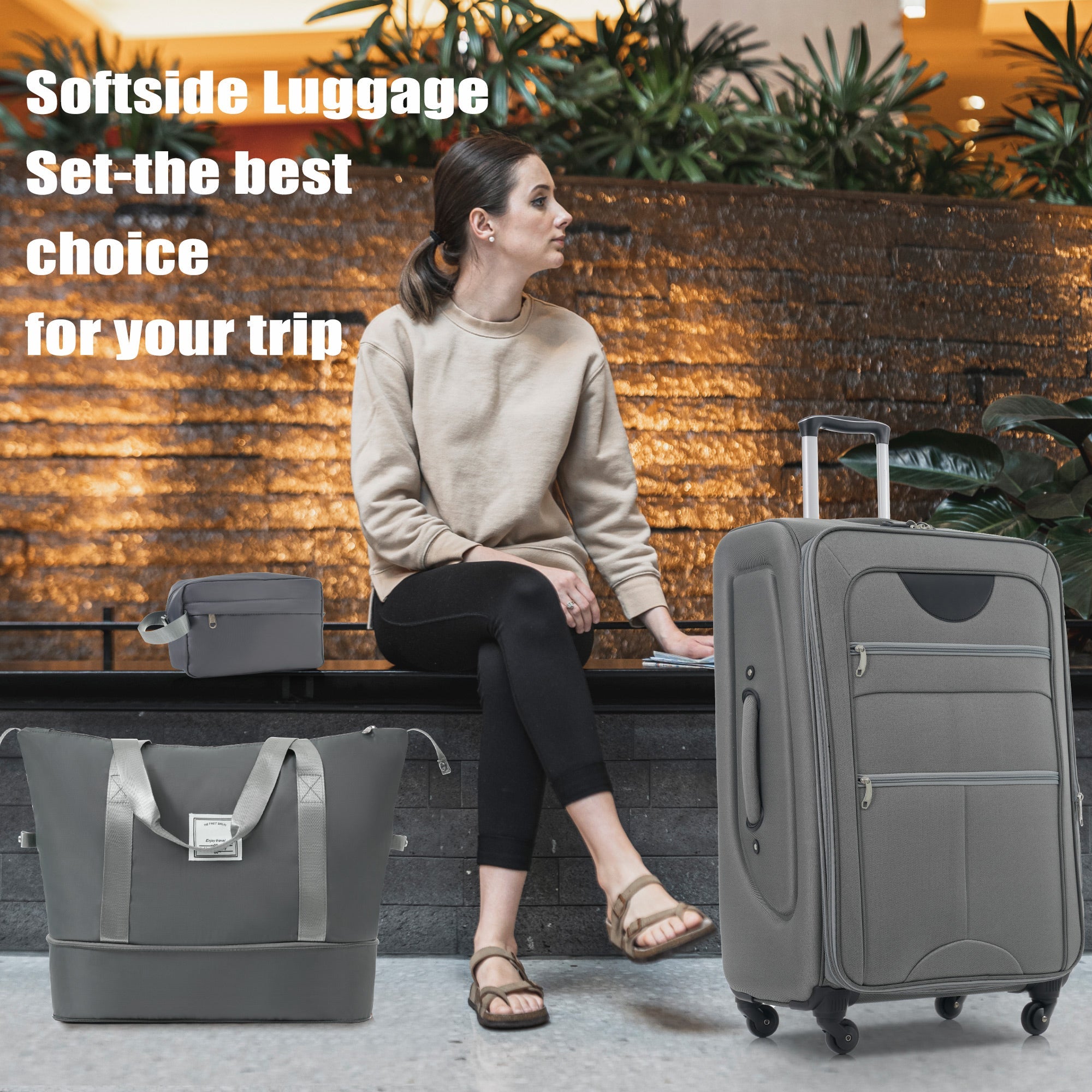 A set of gray softside luggage which includes a 20-inch, 24-inch, and 28-inch suitcase with spinner wheels, a duffel bag, and a toiletry bag.