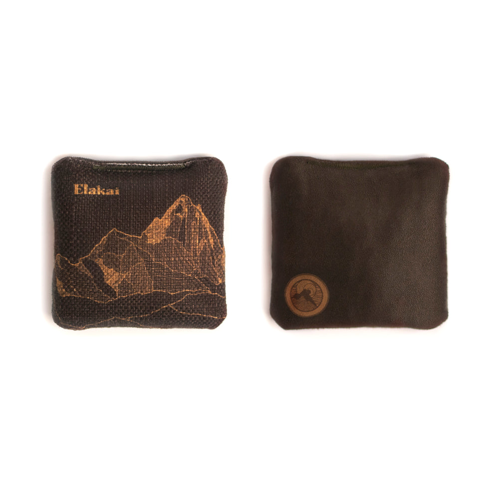 Two brown fabric pouches with mountain design and brand logo on a white background