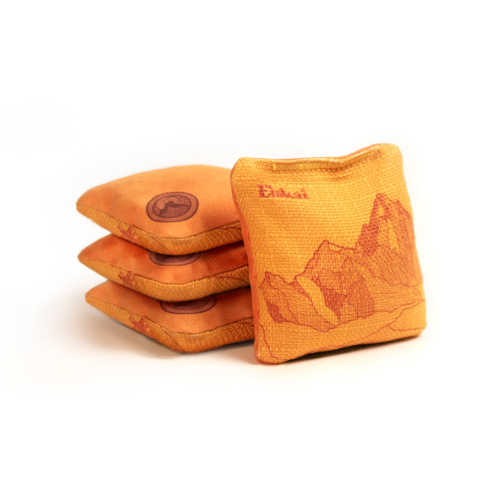 Orange bean bags with a mountain design on a white background