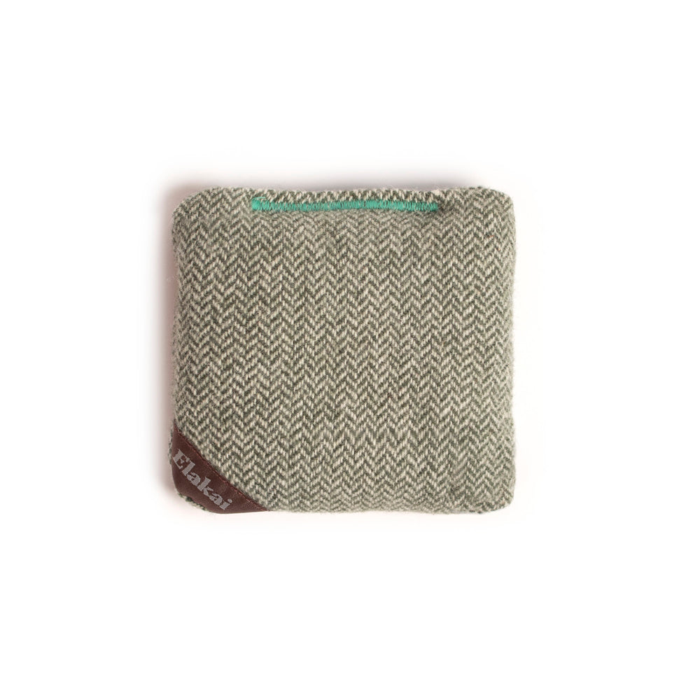 Textured fabric square with a brand label on a white background