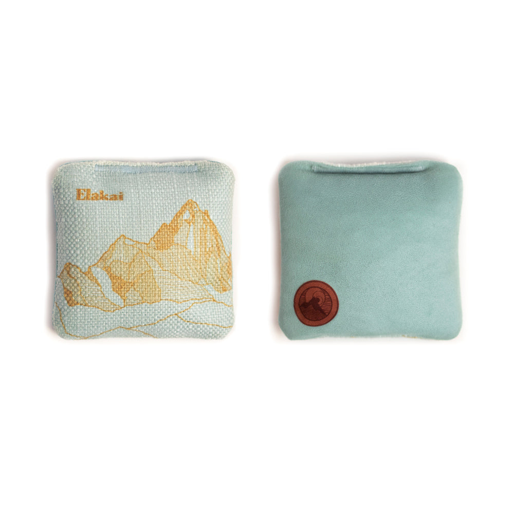 Two fabric pouches with mountain design and brand logo on a white background