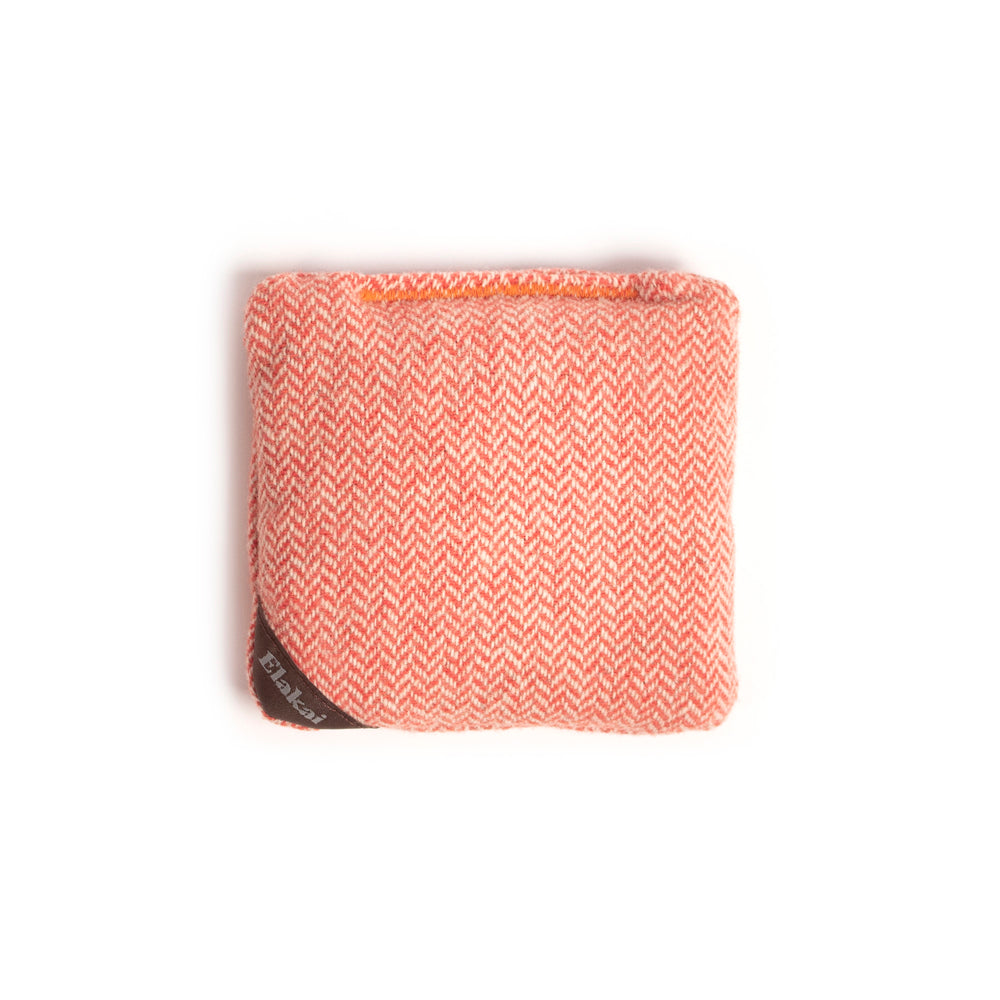 Folded pink and white patterned fabric on a white background