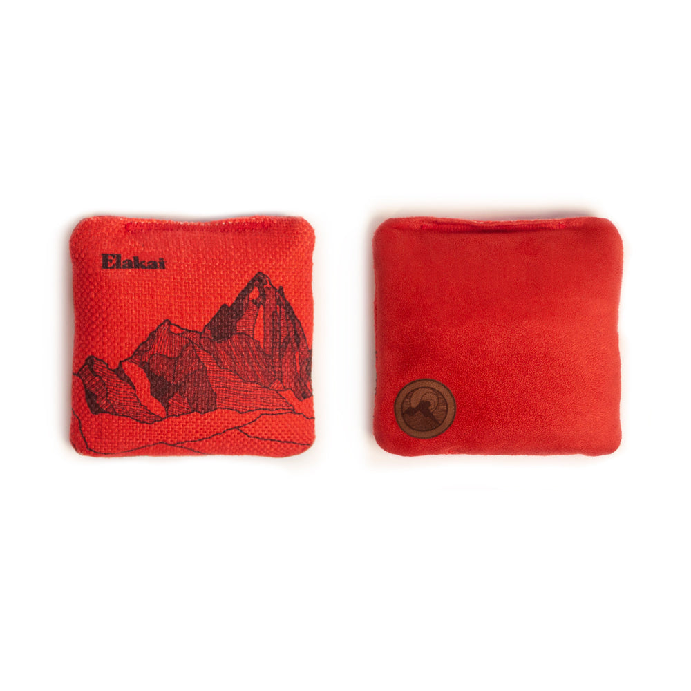 Two red bean bags with mountain design and brand logo on a white background