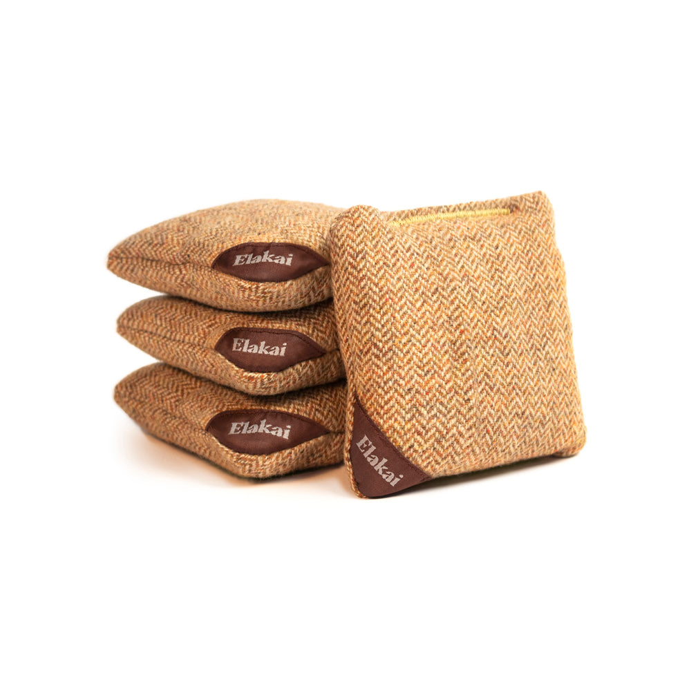 Three woven bags with 'Elakai' branding on a white background