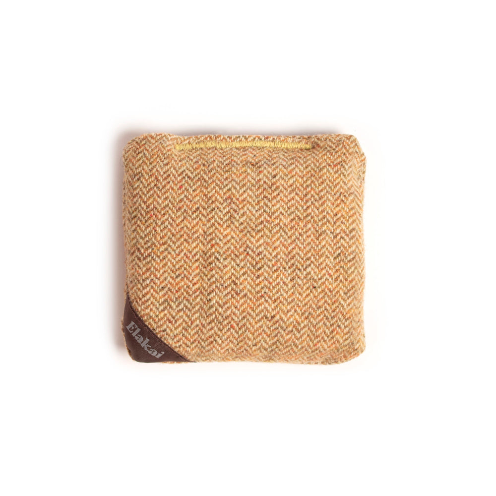 Woven fabric square with a visible brand logo on a white background