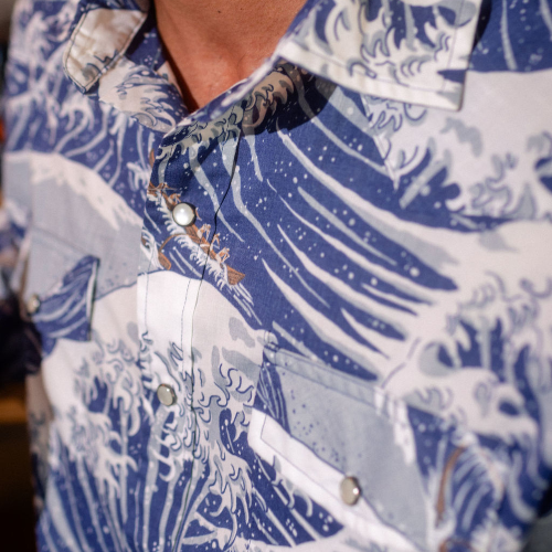 Close-up of a blue and white patterned shirt with buttons.