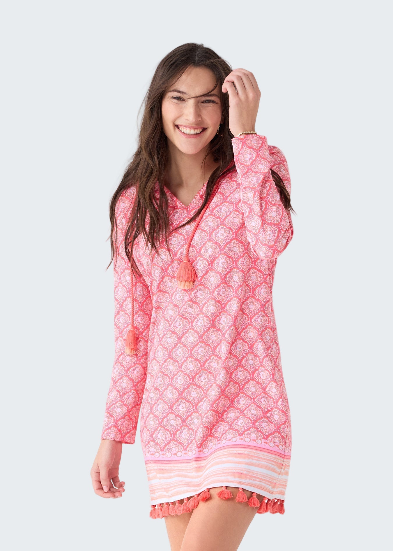 Woman wearing a pink quilted dress with a white background