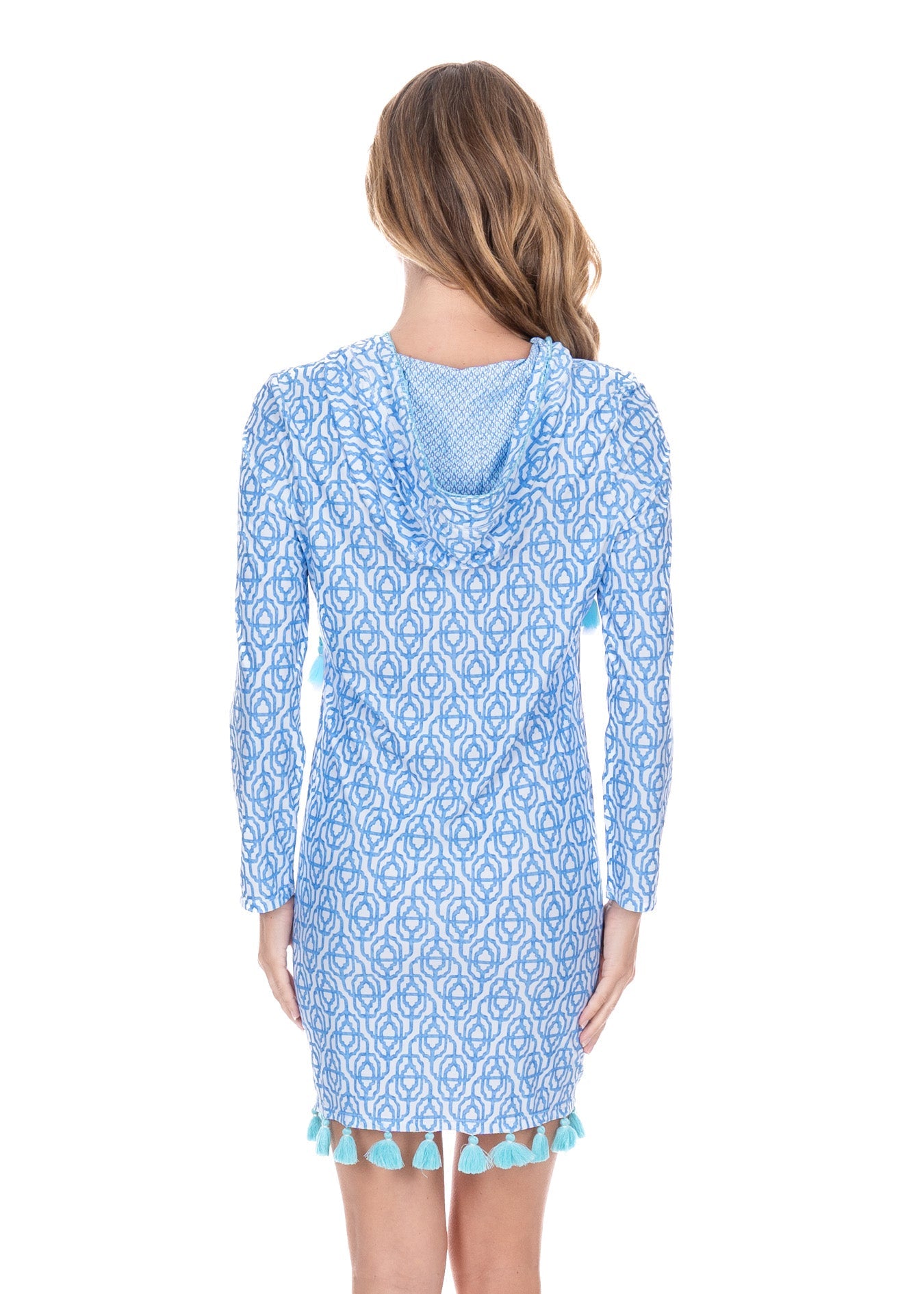 Woman wearing a blue patterned dress with a white background