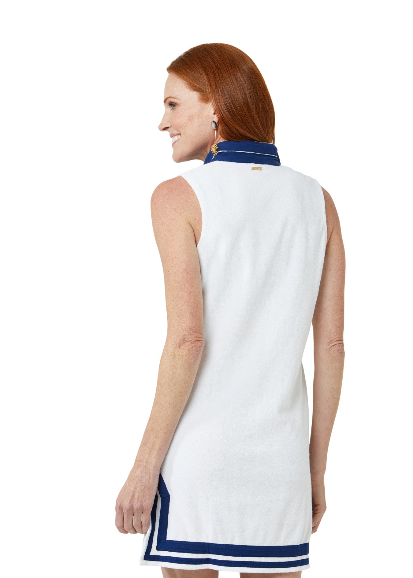 Woman wearing a white dress with blue trim on a white background