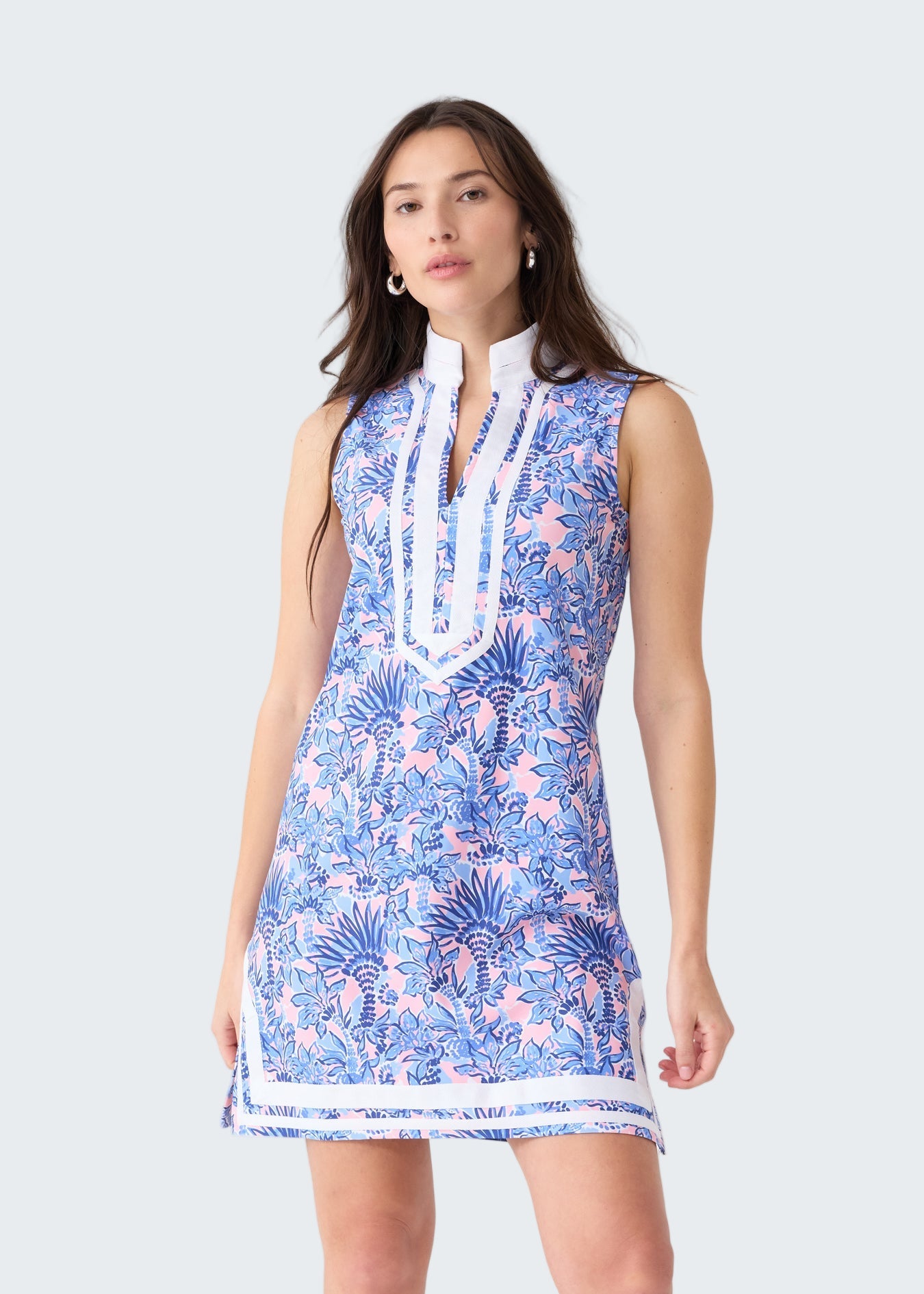 Woman wearing a blue floral dress on a white background