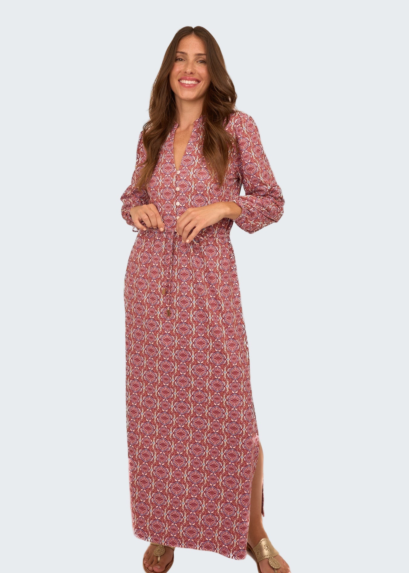 Woman wearing a red patterned dress on a white background