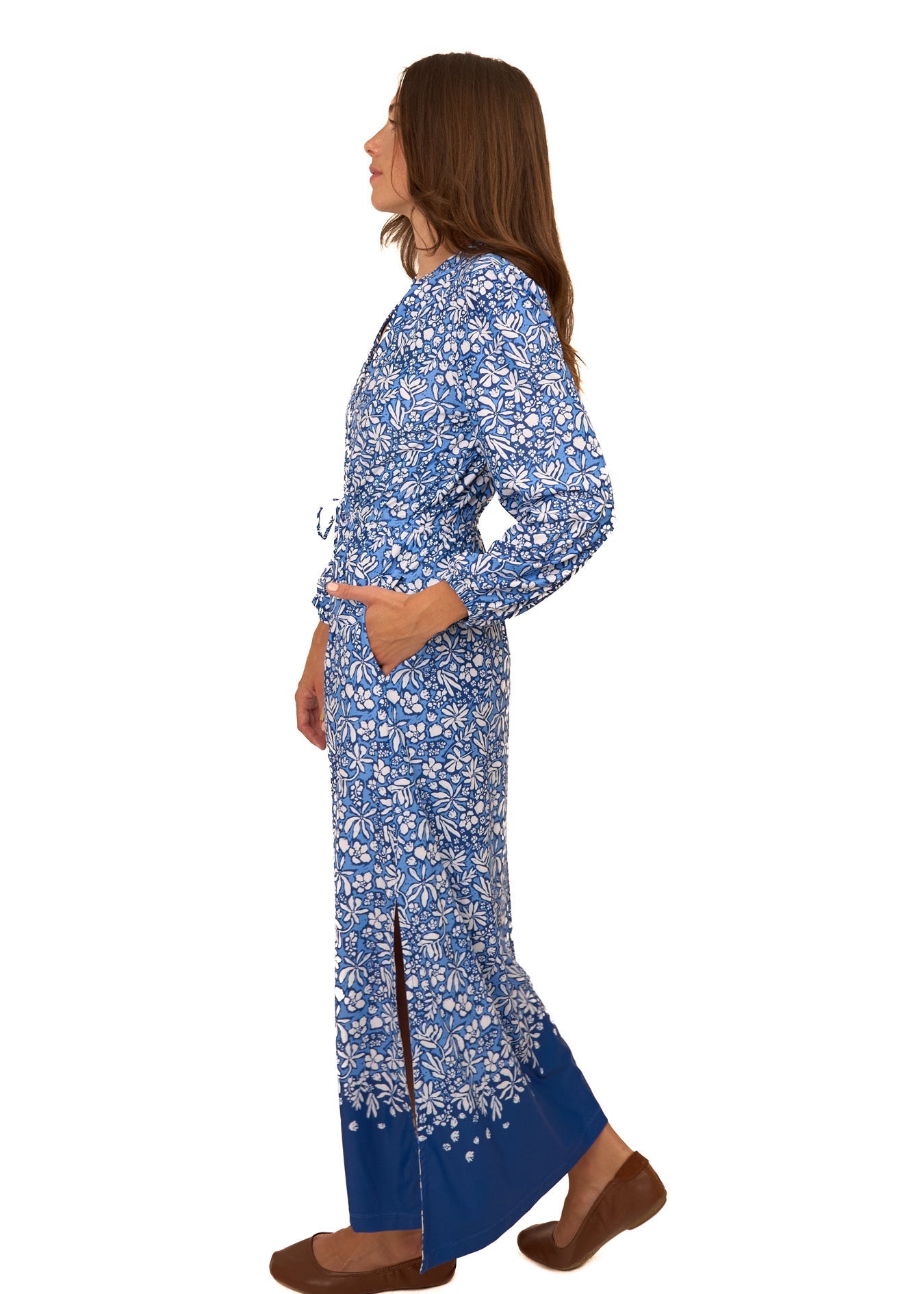 Woman wearing a blue floral dress on a white background