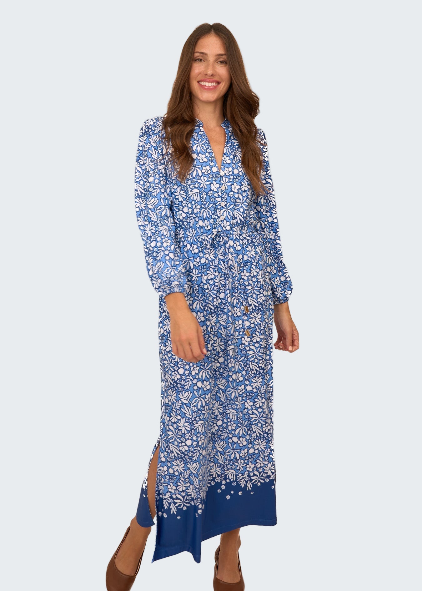 Woman wearing a blue floral dress on a white background