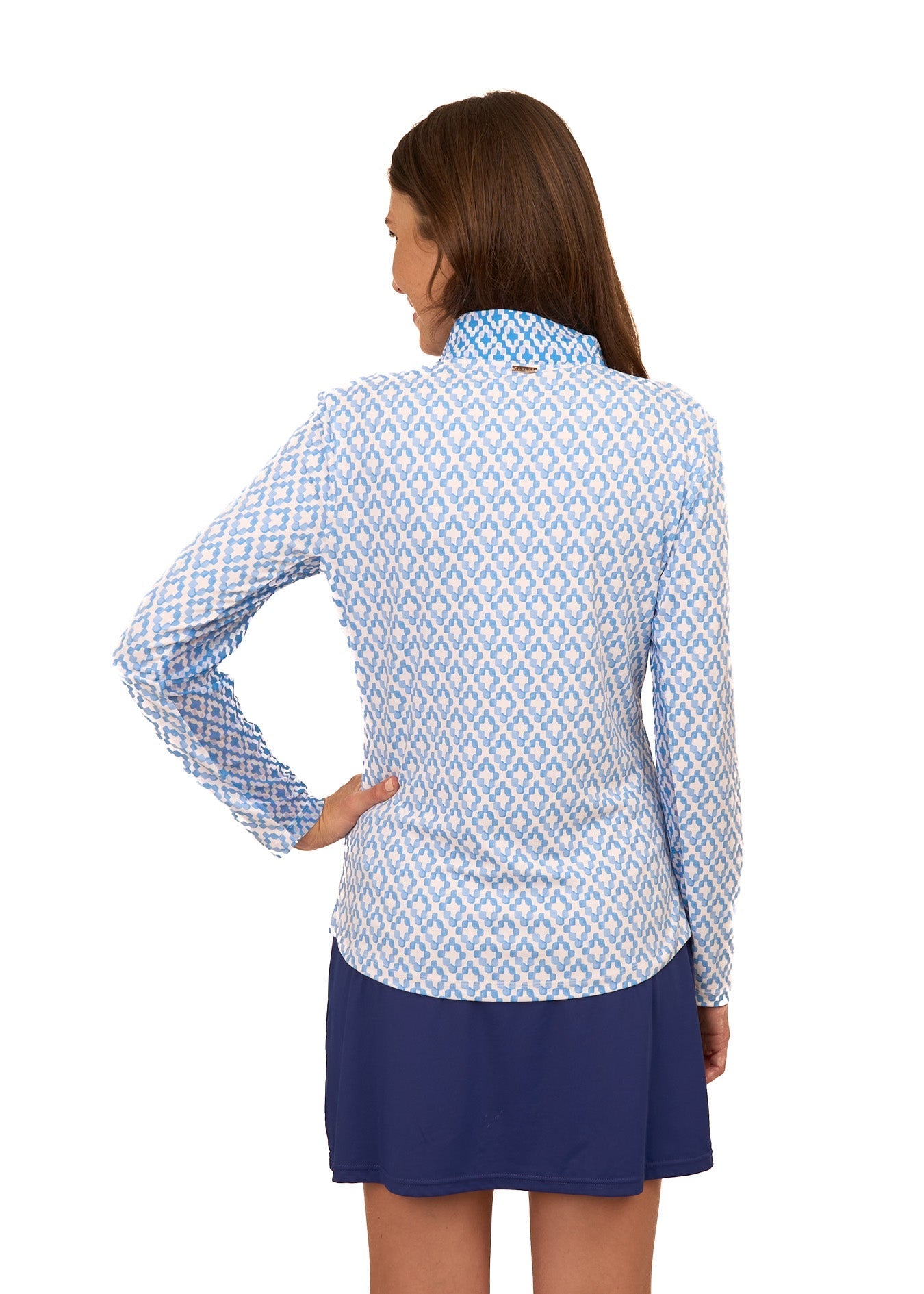 Woman wearing a blue and white patterned shirt with a blue skirt on a white background