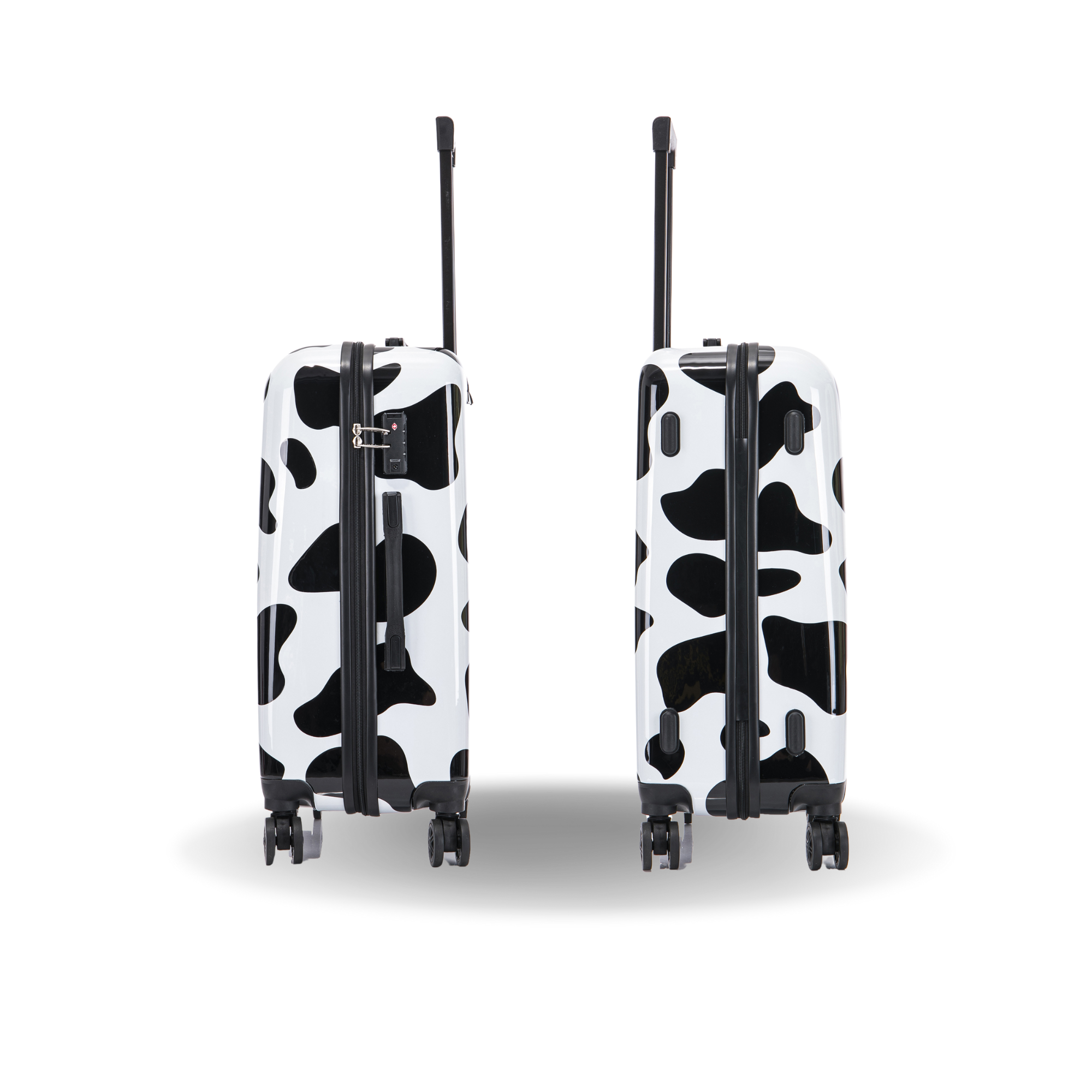 Two cow print suitcases on a white background