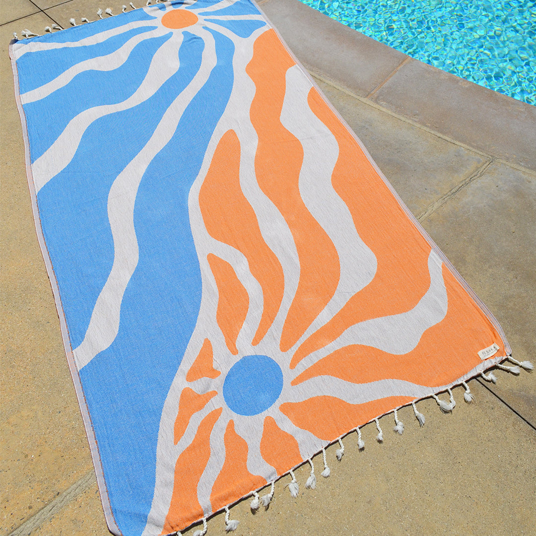 Colorful towel with abstract design on a poolside floor