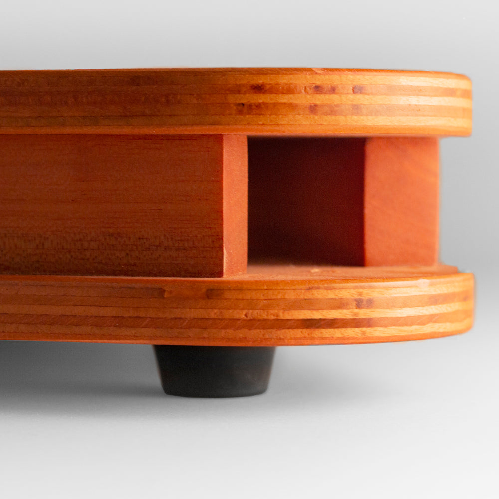 Wooden product with a circular base and rectangular top on a light gray background
