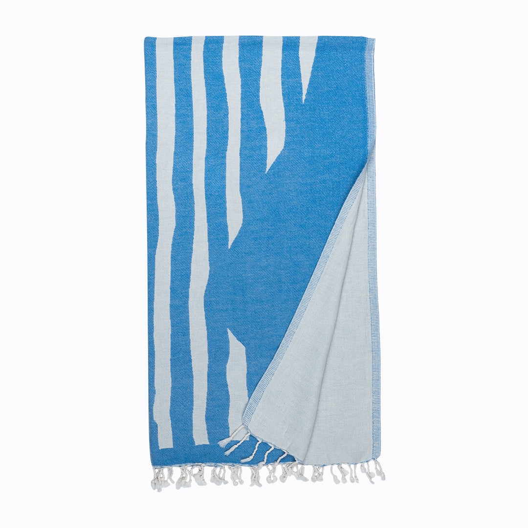 Blue and white striped towel with fringes on a white background