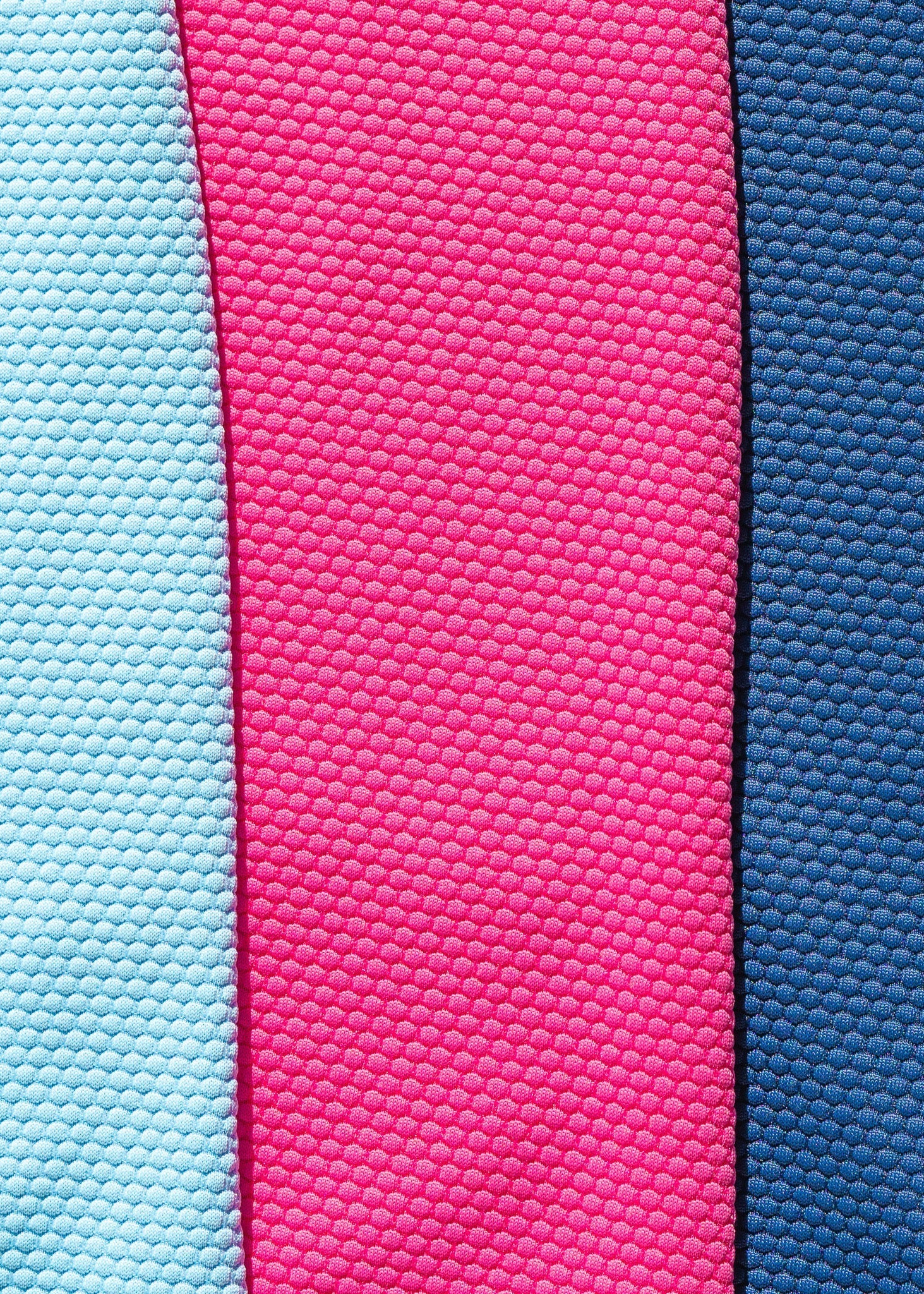 Three rectangular fabric samples in pink, blue, and light blue with textured pattern.