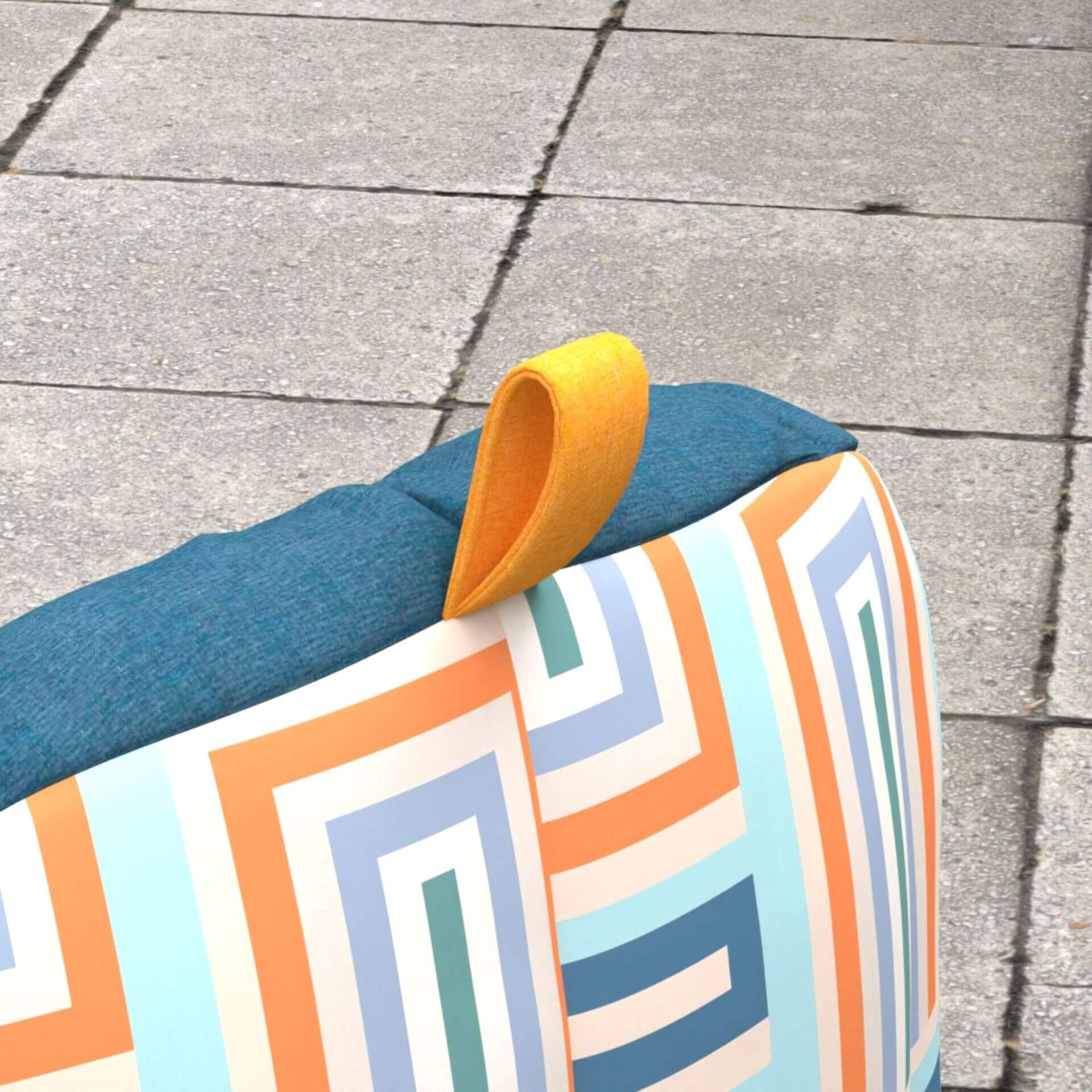 Colorful geometric-patterned dog bed on a concrete surface