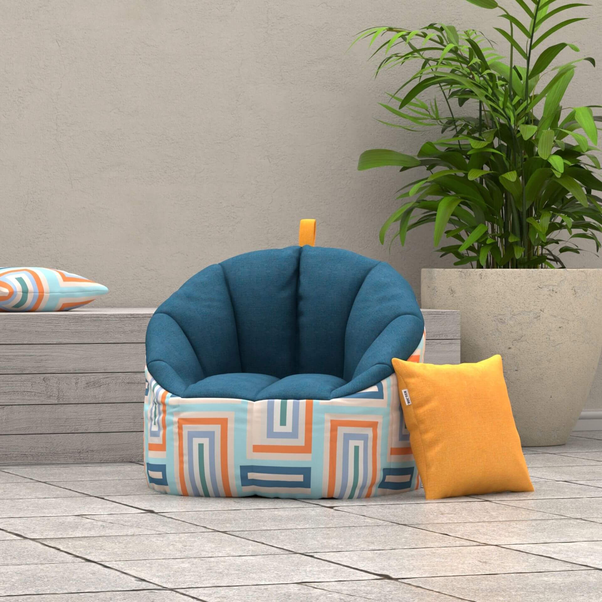 Blue cushioned chair with geometric pattern on a wooden deck, surrounded by a plant and pillows.
