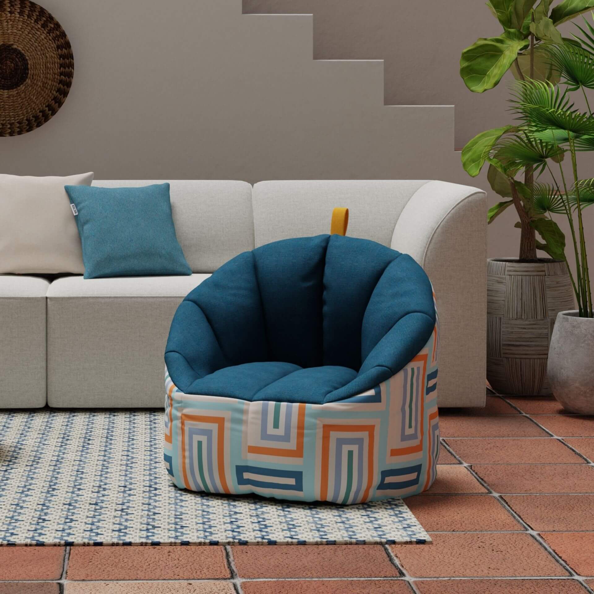 Blue bean bag chair with geometric pattern on a tiled floor next to a white sofa.