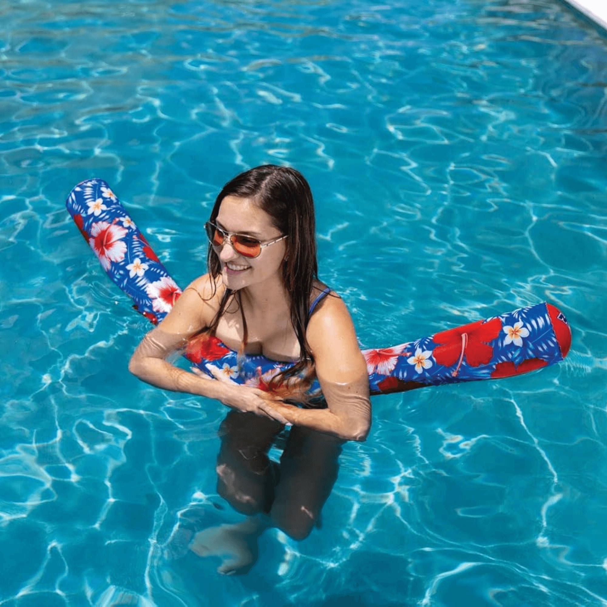 Woman holding a colorful inflatable tube in a pool