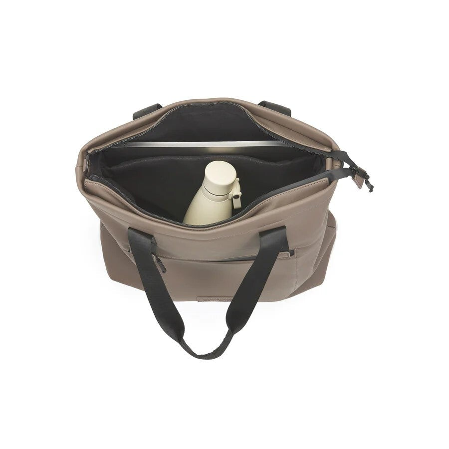 Beige bag with black interior and handles on a white background