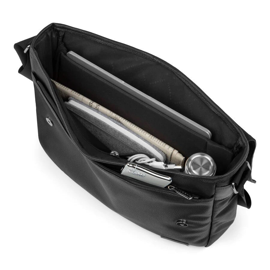 Black crossbody bag with compartments containing a laptop, phone, and other items on a white background