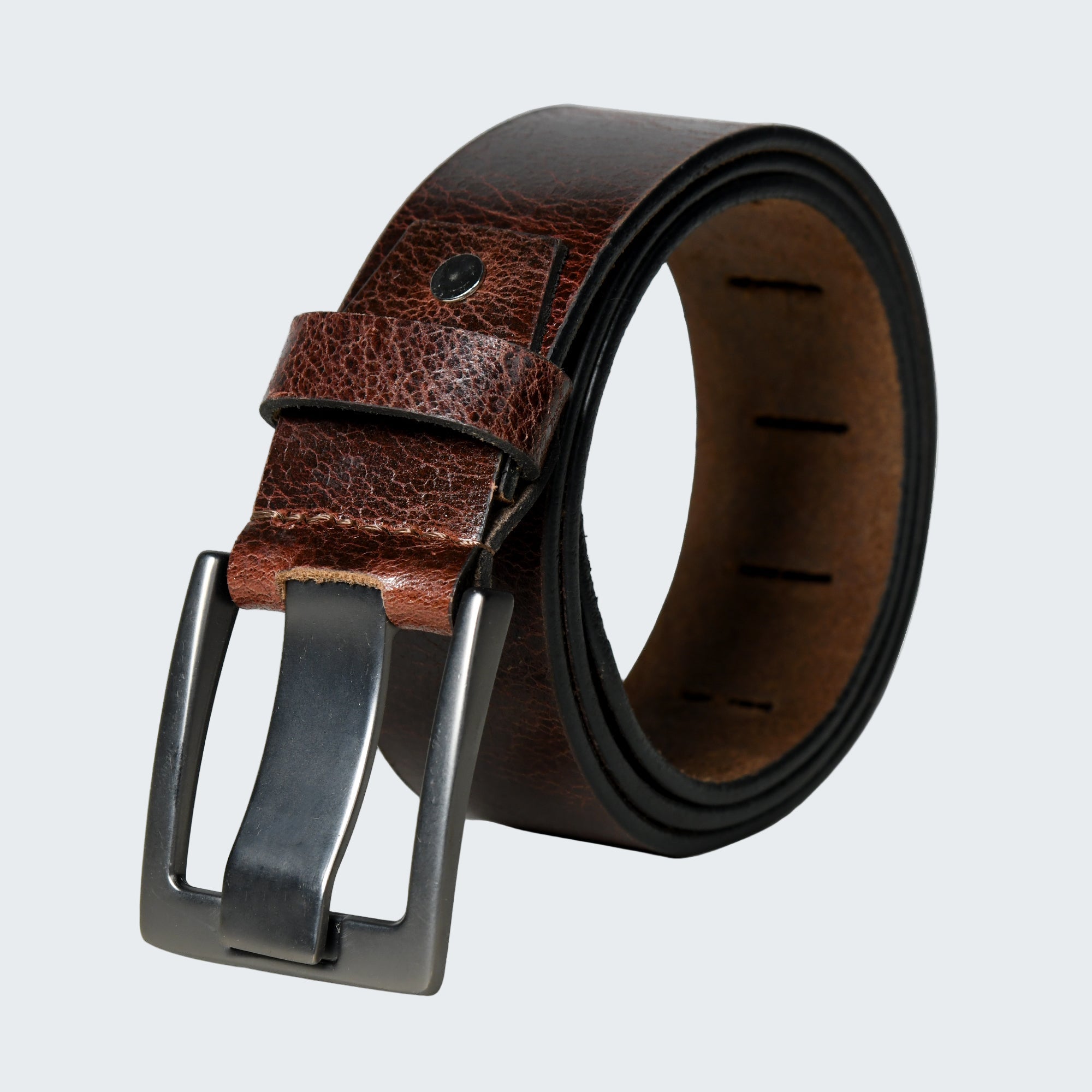 Brown leather belt with a silver buckle on a white background