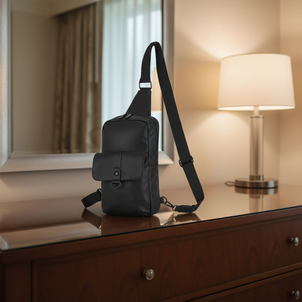 Black sling bag on a white background