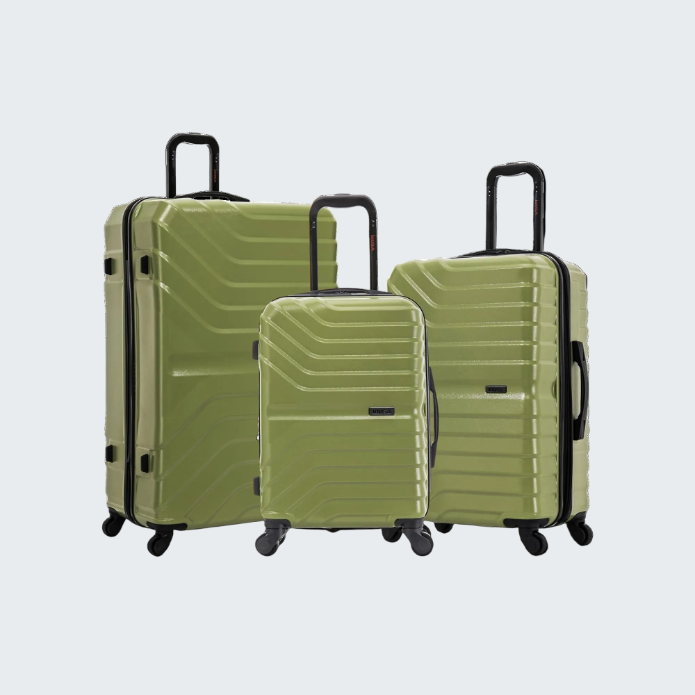 Set of three green suitcases of different sizes on a white background