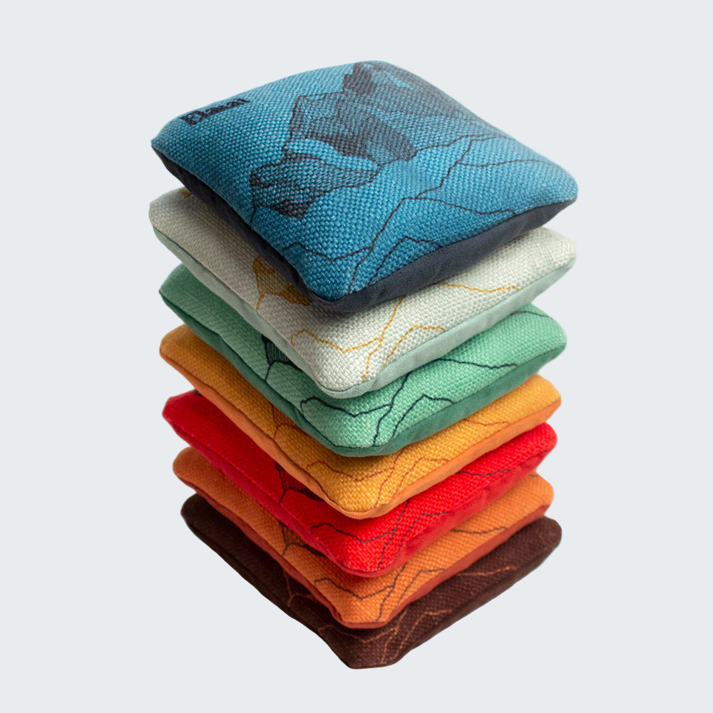 Stack of colorful fabric coasters with a white background