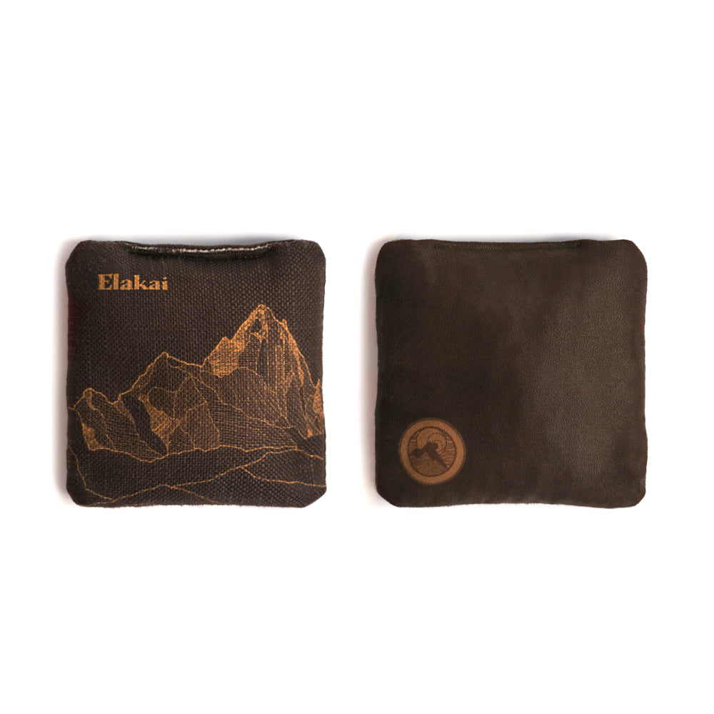 Two brown pouches with mountain design and 'Elakai' branding on a white background