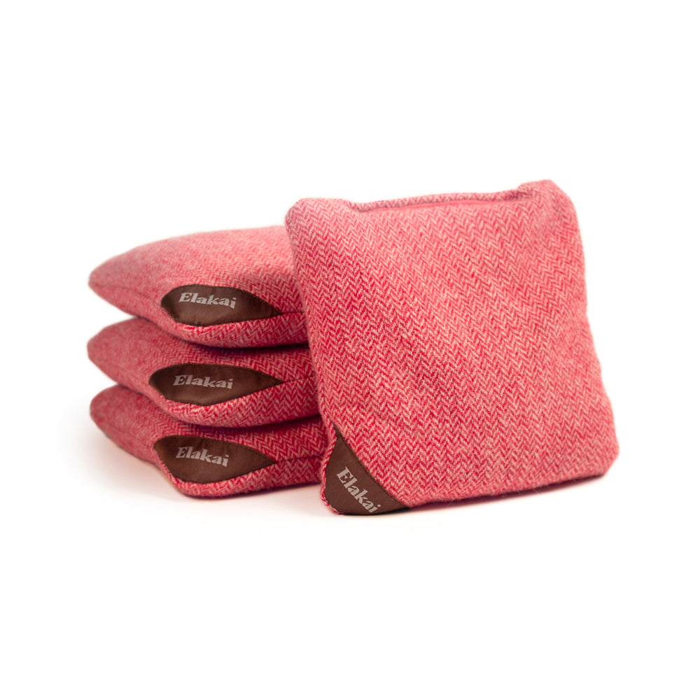 Set of pink herringbone patterned socks with 'Elakai' branding on a white background