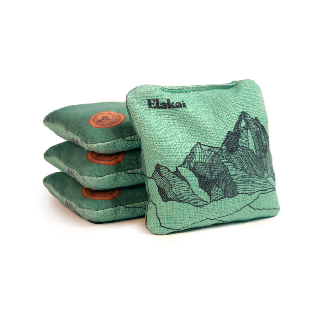 Green bean bags with mountain design and Elakai branding on a white background