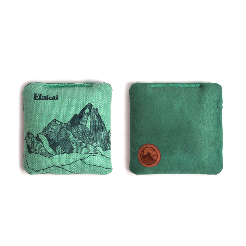 Two green pouches with mountain design and Elakai branding on a white background