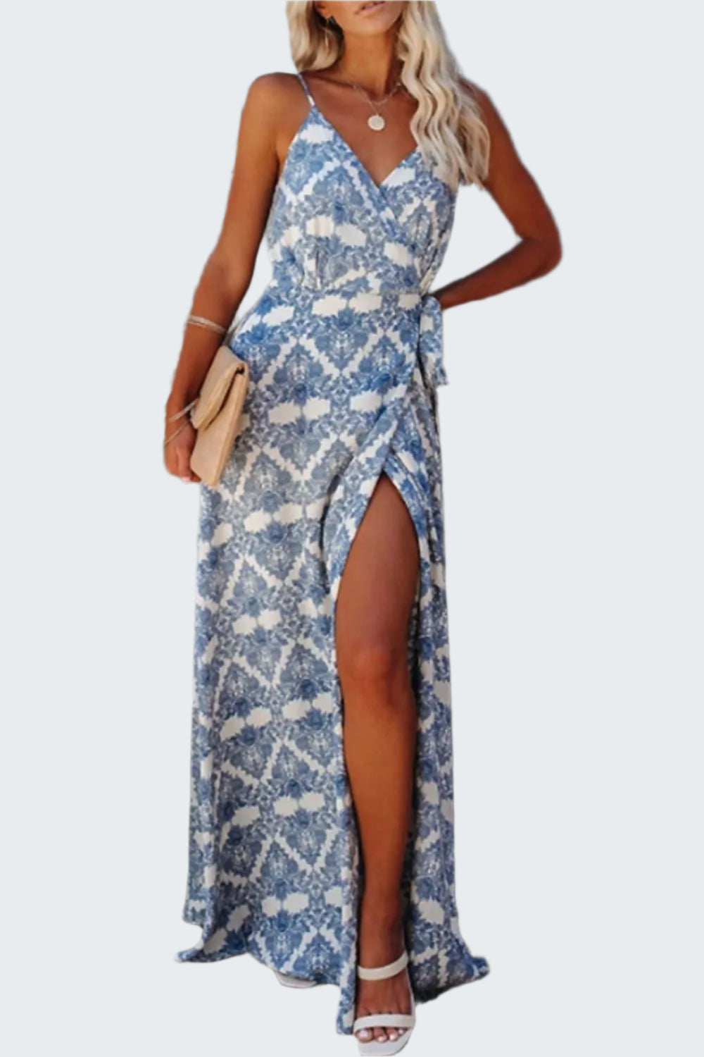 A tied maxi cami dress with a printed design, featuring a V-neckline and sleeveless design. The dress has a high slit on the left side.