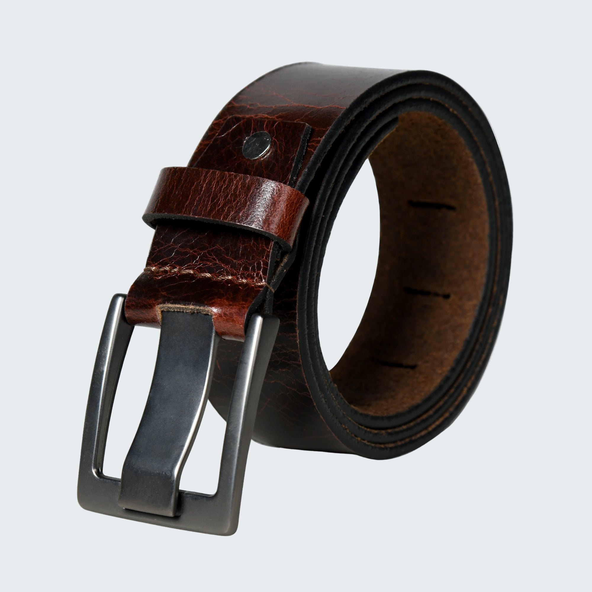 Brown leather belt with a silver buckle on a white background