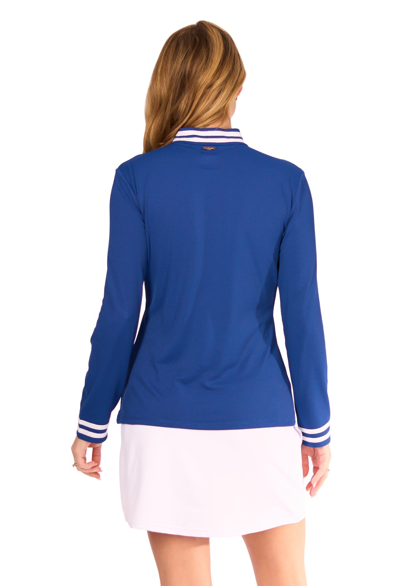 Woman wearing a blue long-sleeve top with white trim on a white background
