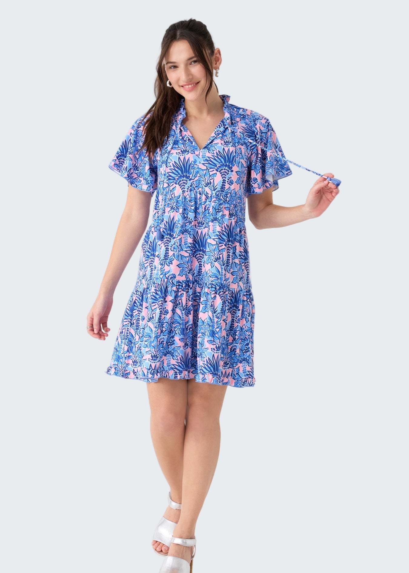 Woman wearing a blue floral dress on a white background