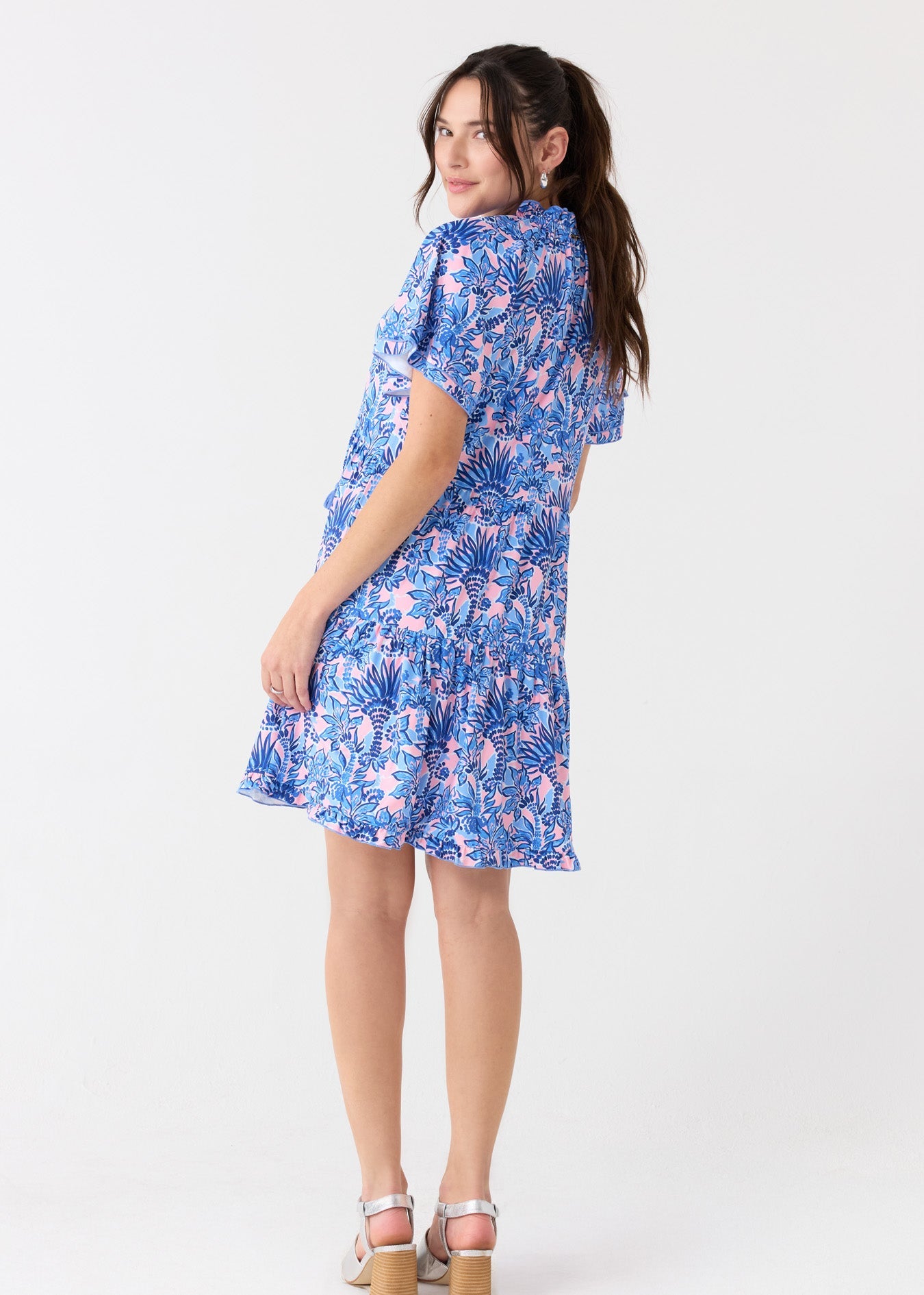 Woman wearing a blue floral dress on a white background