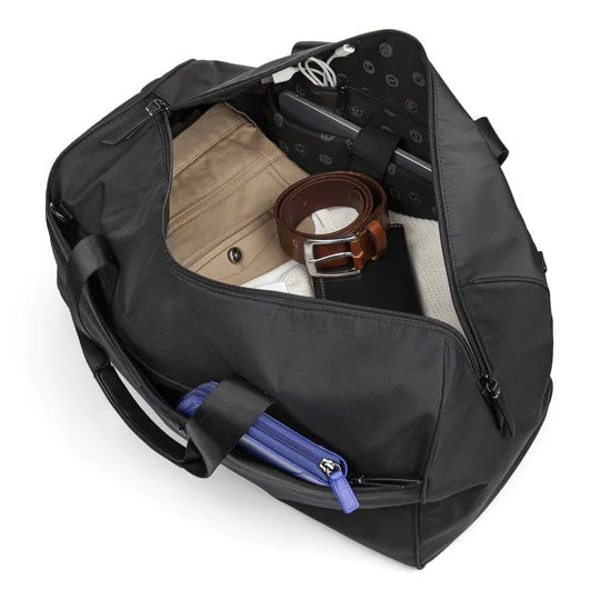 Black duffel bag with various items including a belt and a blue item on a white background
