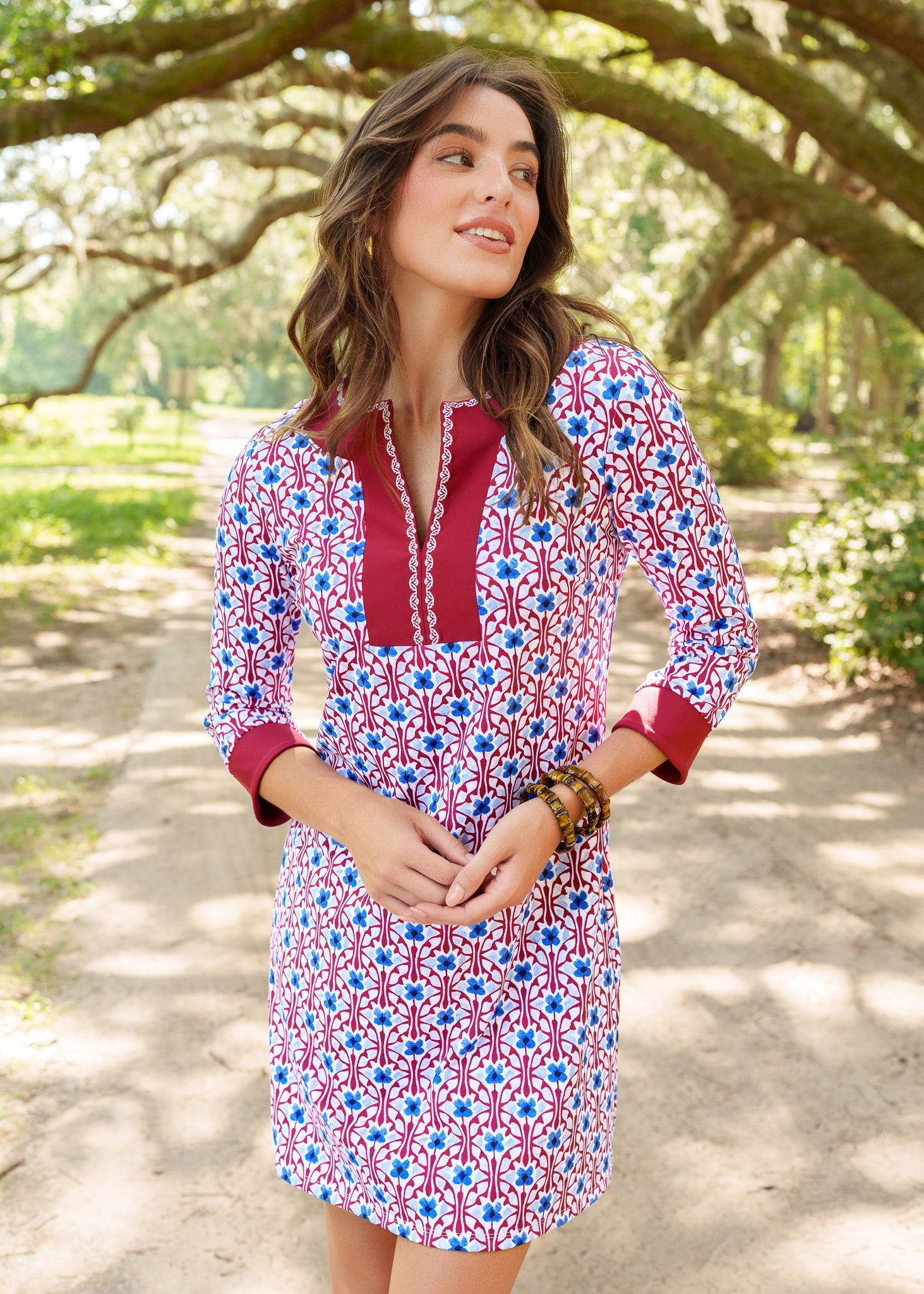 Woman wearing a colorful dress with a pattern in a park setting